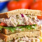 Pinterest graphic for Tuna Salad recipe. Text says, "the best Tuna Salad recipe simplejoy.com." Image shows a stack of Tuna Salad sandwiches