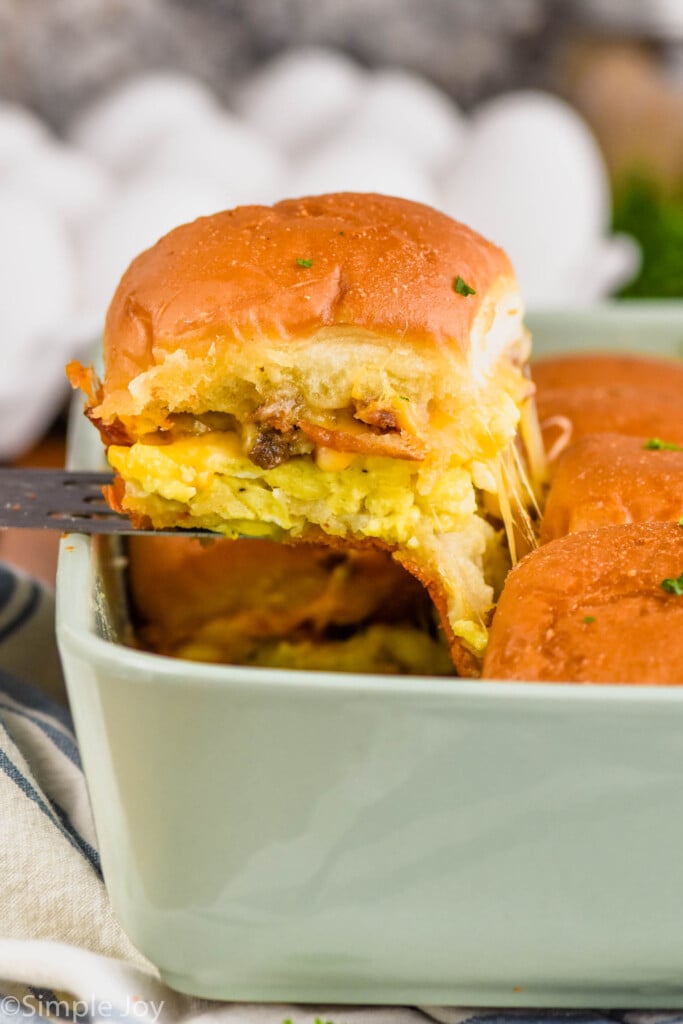 Side view of spatula lifting Breakfast Slider out of baking dish