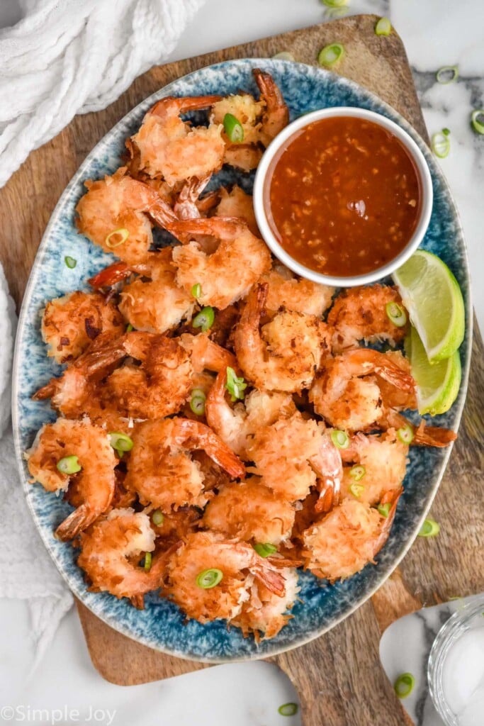 Overhead view of platter of Coconut Shrimp and chili sauce
