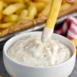 French fry dipping into dish of Garlic Aioli - 9