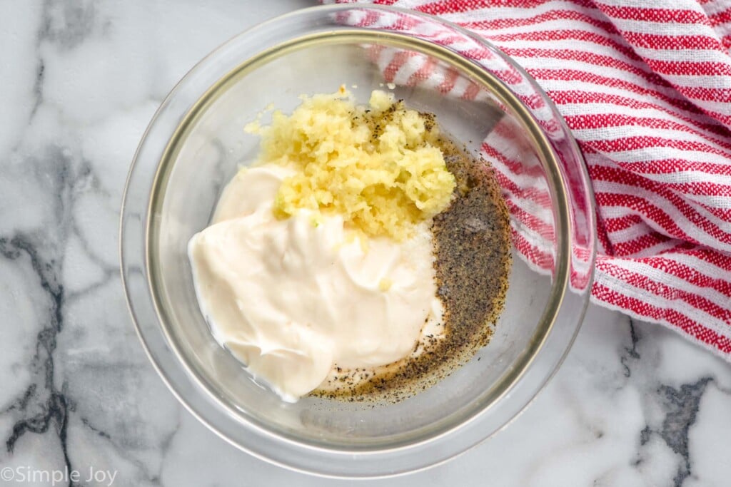 Overhead view of a bowl of ingredients for Garlic Aioli recipe