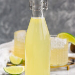 Bottle of Margarita Mix with lime slices beside - 8