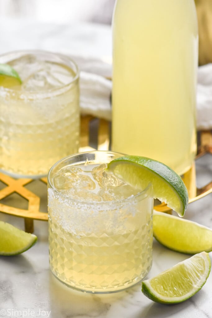 Margaritas with lime wedges