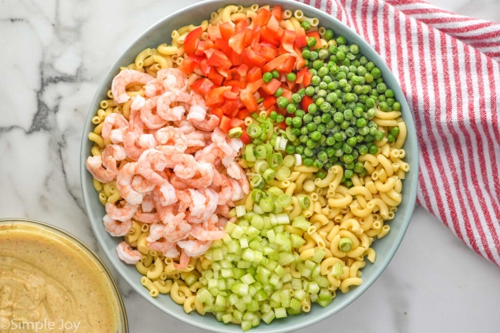 Overhead view of a bowl of ingredients for Shrimp Pasta Salad recipe