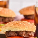 Pinterest graphic for Air Fryer Burgers recipe. Text says, "the best Air Fryer Burgers simplejoy.com." Image is side view of Air Fryer Burger served on a bun with lettuce and tomato.