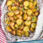 Pinterest graphic for grilled potatoes. Image shows overhead of grilled potatoes in foil. Text says "grilled potatoes simplejoy.com"