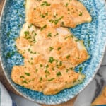 Pinterest graphic for Melt In Your Mouth Chicken recipe. Image shows Melt In Your Mouth Chicken on a platter. Text says, "Melt In Your Mouth Chicken simplejoy.com"