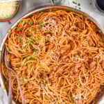 Pinterest graphic for Sausage Spaghetti recipe. Text says, "the best Sausage Spaghetti simplejoy.com." Image shows a pot of Sausage Spaghetti.