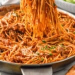 Pinterest graphic for Sausage Spaghetti recipe. Image shows forks lifting Sausage Spaghetti. Text says, "super easy Sausage Spaghetti simplejoy.com"
