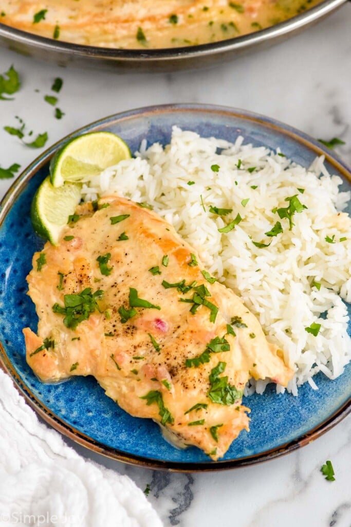 plate of Coconut Lime Chicken, rice, and lime wedges for garnish