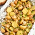 grilled potatoes in foil garnished with shredded cheese and parsley - 9