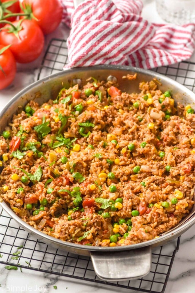 side view of a large skillet with Ground Beef and Rice, garnished with cilantro