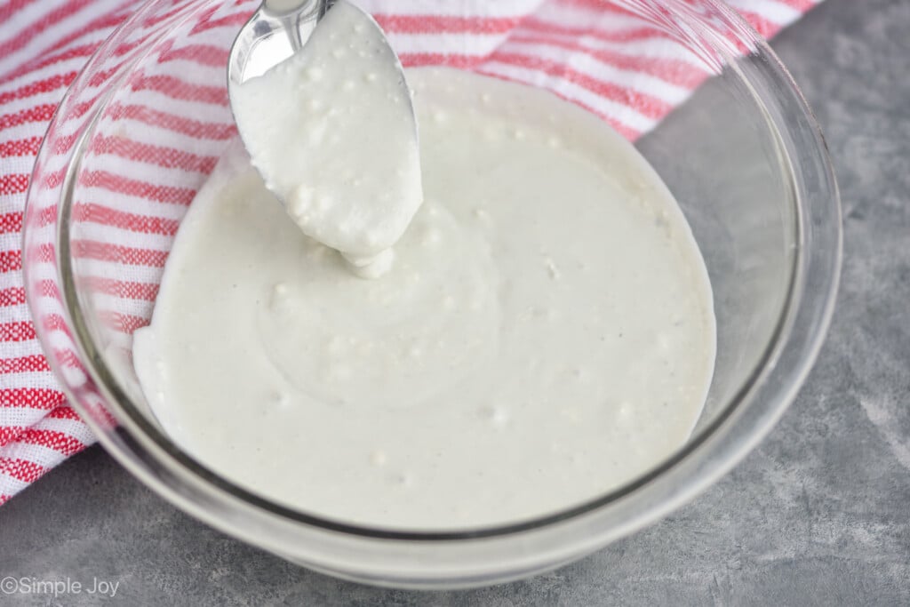 a bowl of blue cheese dressing with a spoon in it - 10