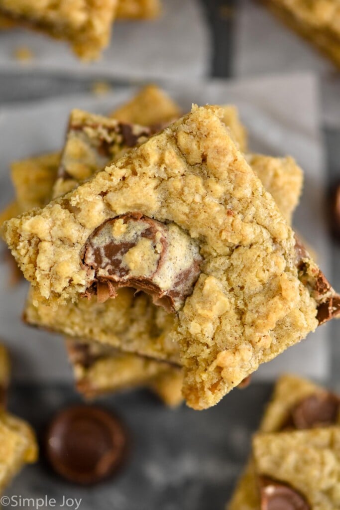 overhead of a stack of oatmeal rolo bars with a bite missing from the top one