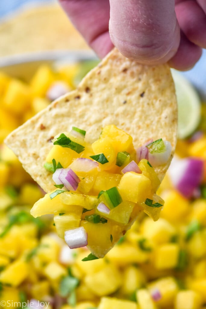 close up of a chip with pineapple salsa on it