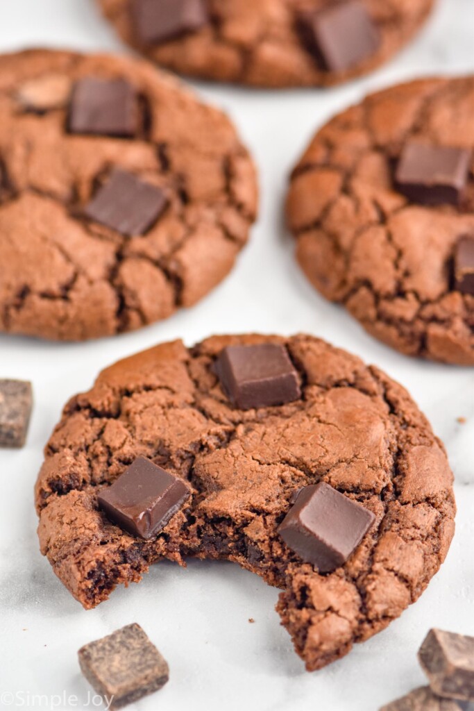 Triple Chocolate Cookies with a bite taken out of front cookie