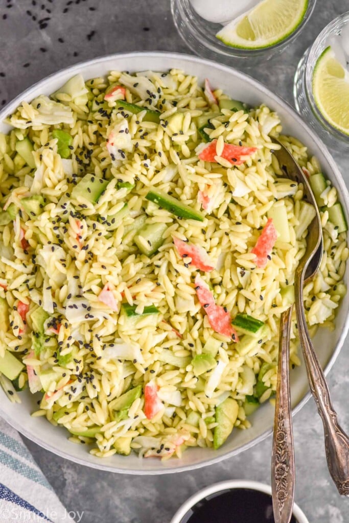overhead of bowl of California Roll Pasta Salad with spoons for serving