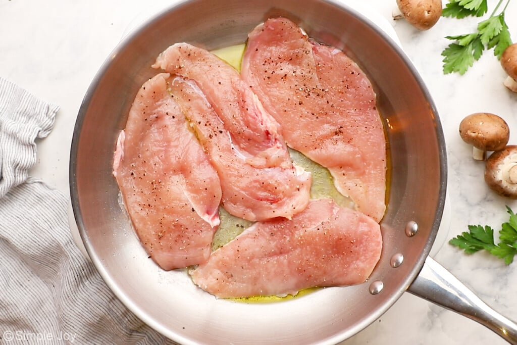 cooking chicken in a pan to make chicken marsala