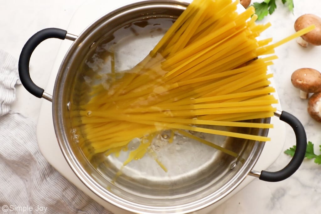 overhead of fettuccine in a pot of water