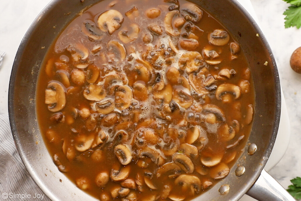 overhead of mushrooms cooking in marsala sauce