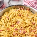 Pinterest graphic for Pasta Carbonara recipe. Text says, "the best carbonara recipe simplejoy.com." Image shows a pot of Pasta Carbonara.