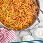 Pinterest graphic for Taco Spaghetti. Image shows overhead of skillet of Taco Spaghetti . Text says "Taco Spaghetti simplejoy.com"