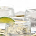 Pinterest graphic for Vodka Tonic recipe. Text says, "the best Vodka Tonic simplejoy.com." Image shows Vodka Tonic garnished with lime wedge. Lime wedges beside.