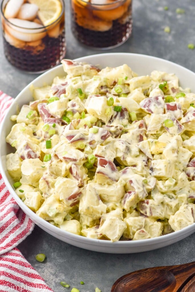 bowl of Potato Salad with two glasses of iced tea with ice and lemon sitting in background