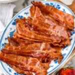 plate of bacon cooked in the oven. Fresh strawberries, blueberries, bowl of scrambled eggs and mug of coffee surrounding - 11