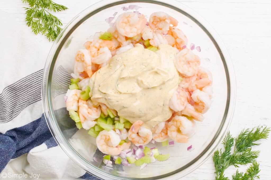 overhead of a bowl of ingredients for shrimp salad with dressing