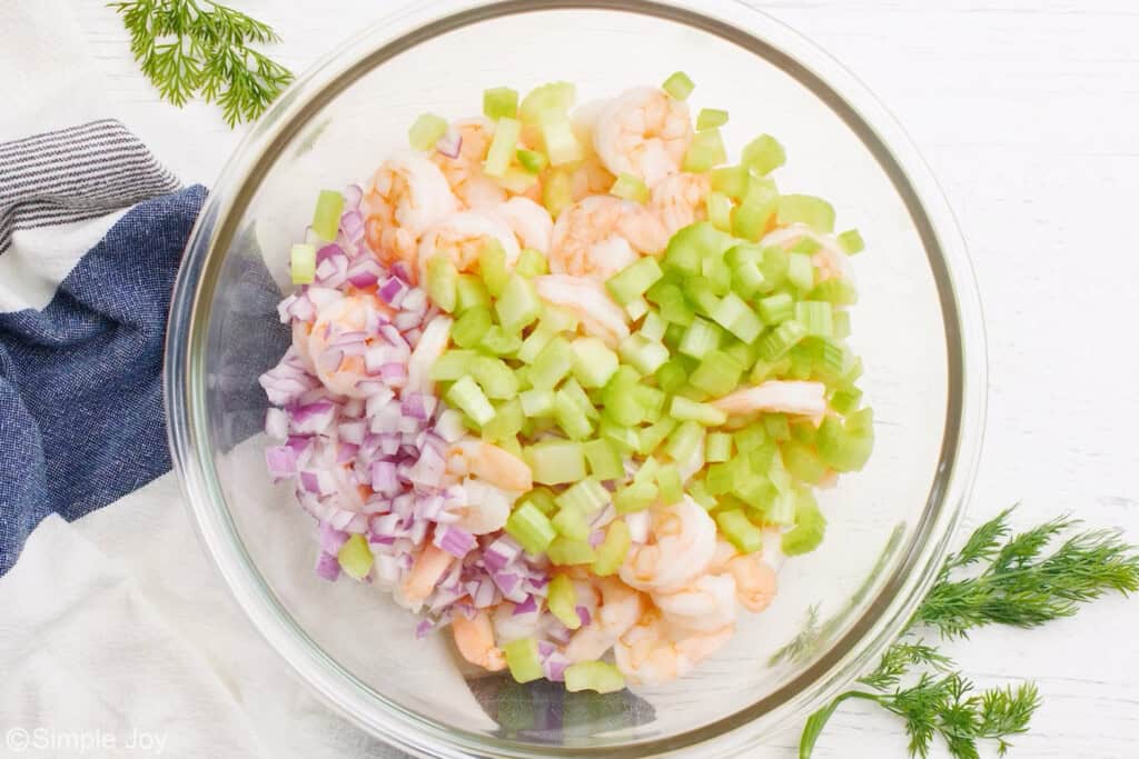overhead view of a bowl of ingredients to make shrimp salad