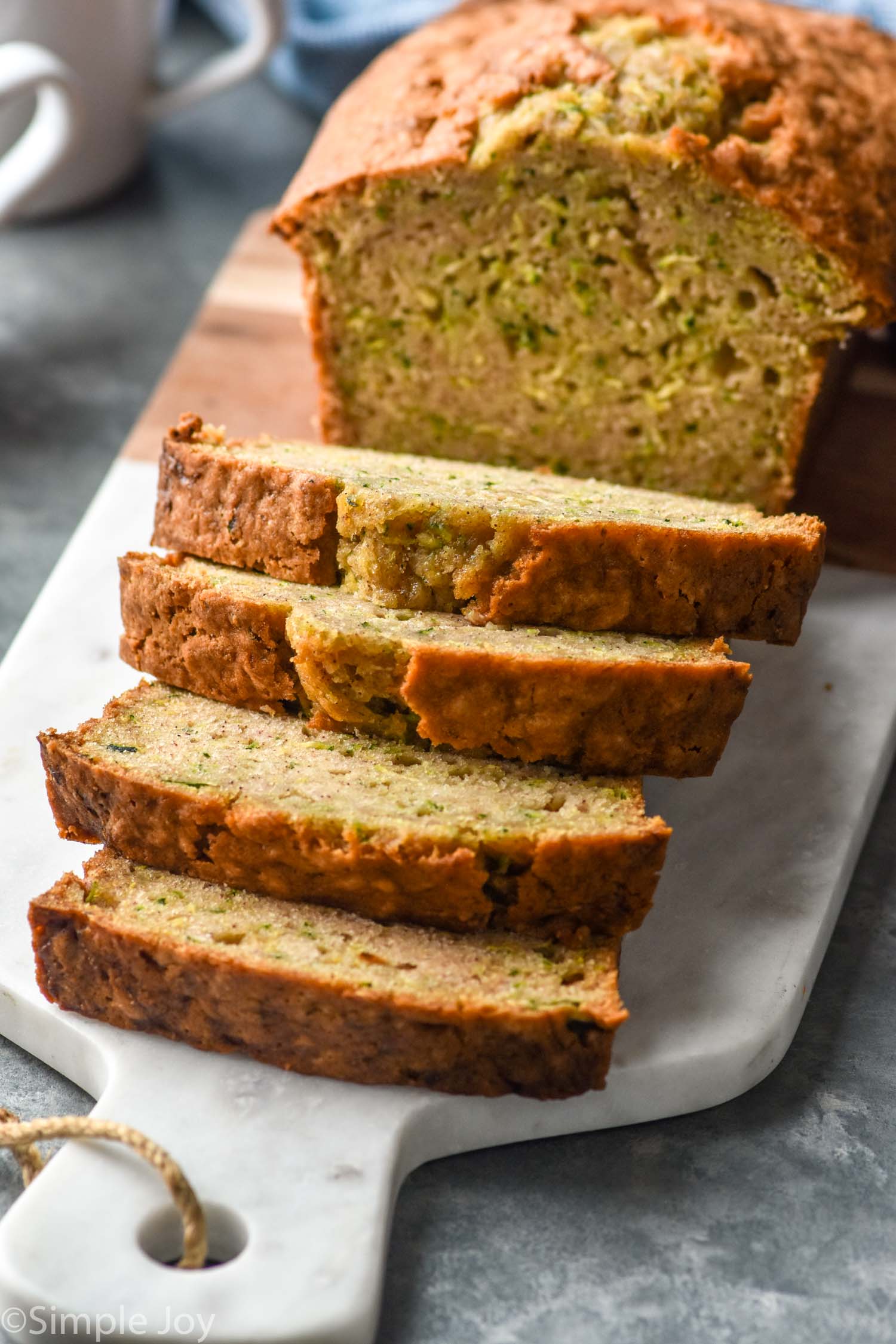 sliced loaf of Zucchini Bread on a cutting board
