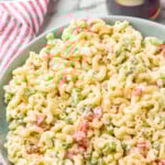 Pinterest graphic for Macaroni Salad. Text says "amazing Macaroni Salad simplejoy.com" Image shows bowl of Macaroni Salad with two forks for serving.