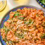 Pinterest graphic for Risotto. Text says "the best sausage Risotto simplejoy.com" Image shows overhead of plate of risotto with spinach and shredded parmesan cheese.