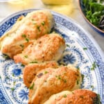 Pinterest graphic for Stuffed Chicken Breast. Text says "the best stuffed chicken simplejoy.com" Image shows 5 Stuffed Chicken Breasts on a platter