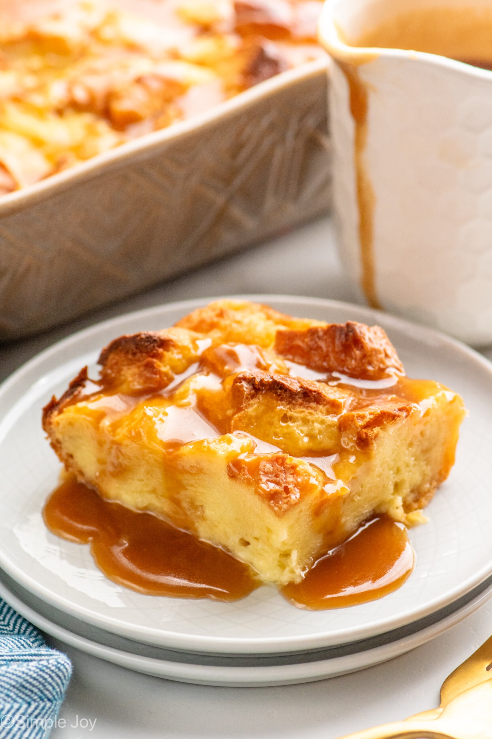 Piece of Bread Pudding with sauce served on plate.