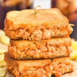 Stack of Buffalo Chicken Sandwich halves with potato chips sitting in background - 17
