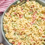 Overhead of bowl of Macaroni Salad with two forks for serving