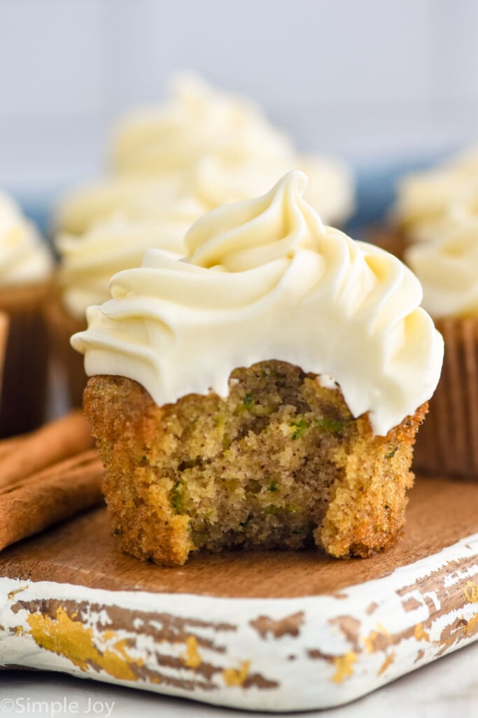 Zucchini Cupcake with bite taken out, topped with cream cheese frosting