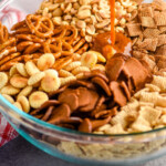 pinterest graphic of Chex mix seasoning being poured over the ingredients, says "the most delicious Chex mix simplejoy.com"