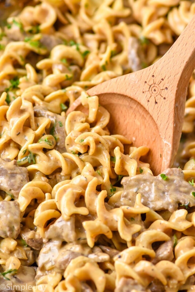 close up of wooden spoon in Beef Stroganoff