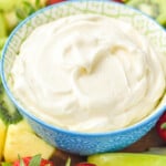 bowl of Fruit Dip surrounded by fresh strawberries, pineapple, and apple slices - 11