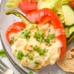 White Chicken Chili Stuffed Pepper topped with parsley on a plate with salad - 11