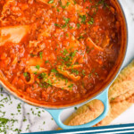 Pinterest graphic for Lasagna Soup. Image shows overhead of large soup pot of Lasagna Soup topped with fresh parsley. Text says "Lasagna Soup simplejoy.com"
