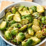 bowl of Air Fryer Brussels Sprouts topped with parmesan cheese with a fork - 10