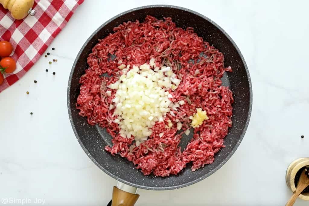 Overhead of skillet of ingredients to make chili dogs