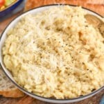 bowl of Instant Pot Risotto topped with black pepper and shredded parmesan cheese. - 8