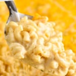 pinterest graphic of a large serving spoon dishing up baked Mac and cheese recipe, says: "the best baked Mac & cheese simplejoy.com"