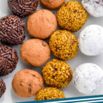 Pinterest graphic for Chocolate Truffles. Image shows overhead of chocolate covered in sprinkles, cocoa powder, gold sprinkles, and powdered sugar