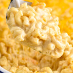 a large serving spoon dishing up baked Mac and cheese recipe - 12